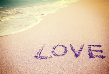 Love inscribed in the sand of a beach
