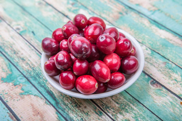 Cranberries fruit over wooden background