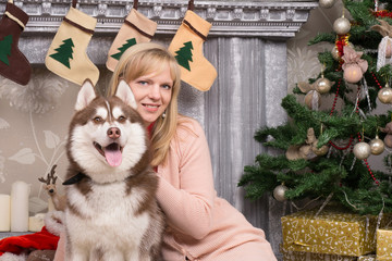 Beautiful blond young woman is sitting with a Husky dog at New Y