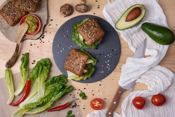 Homemade organic vegetarian mushroom burger with tomato and guacamole, top view.