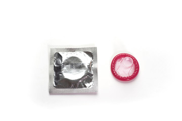 Condom and package on white background