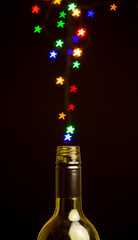 colorful star shape lights floating out of the bottle