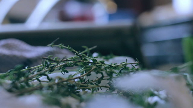 woman's hands selecting fresh thyme for cooking