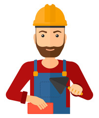 Bricklayer with spatula and brick.