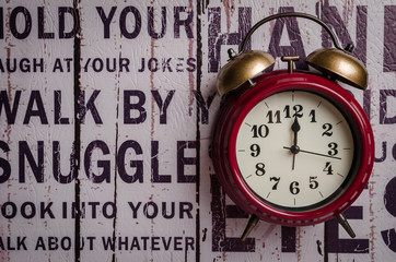 Red retro alarm bell clock on texture background