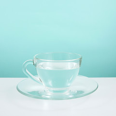 The glass cup of pure water on a white table.