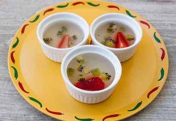 Fruit strawberry and kiwi jelly dessert on the wood background