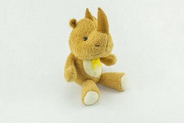 fabric rhino doll on white background - cute toy and copy space