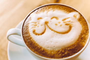 Coffee cup with artistic cream cat face decoration