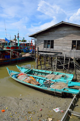 Fototapeta na wymiar Colorful chinese fishing boat resting at a Chinese Fishing Village- Sekinchan, Malaysia..