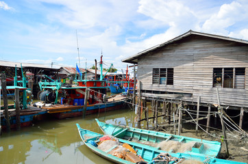 Fototapeta na wymiar Colorful chinese fishing boat resting at a Chinese Fishing Village- Sekinchan, Malaysia..