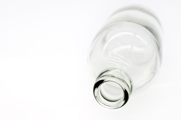 Selective focus at detail of glass bottle on white background. Concept image