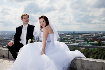 luxury romantic gorgeous holding hands bride and groom on the background of old sunny city