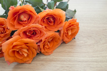 Fresh orange roses on wooden background with copy space for some text, Concept of love, Valentines Day background, wedding day