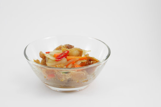 The Thai stir fried crispy pork in the small glass bowl.