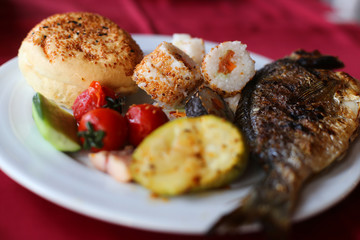 roasted codfish fillet with vegetables, selective focus
