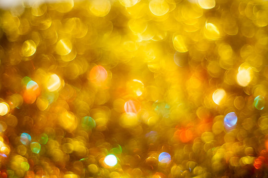 Fairy Christmas background. Colorful twinkles on Bright golden sparkles of holiday shining
