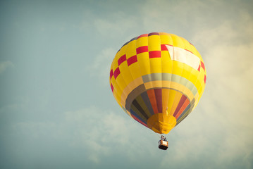 Multicolor hot air balloon on sky with cloud, vintage color effect