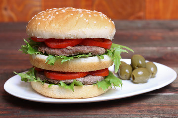 Closeup of home made burgers on wooden background