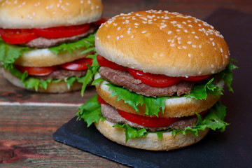 Closeup of home made burgers on wooden background