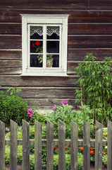 Fototapeta na wymiar Window of an old traditional log house