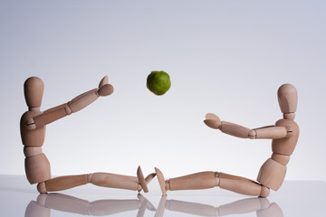 Two wooden puppet playing togheter