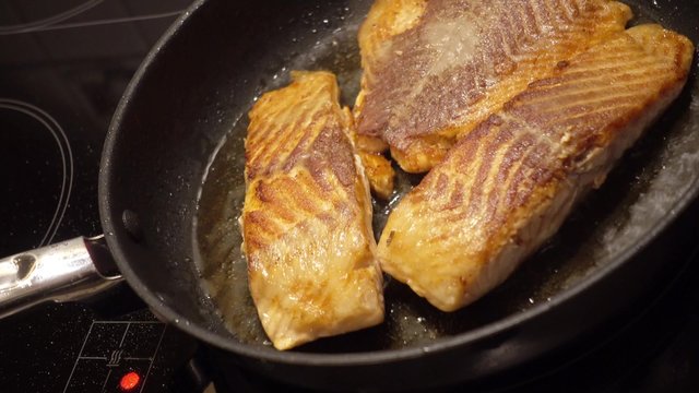 three salmon steaks in the pan