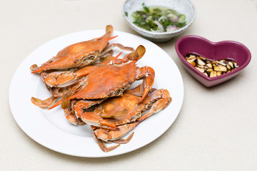 Boiled blue crabs with sauces