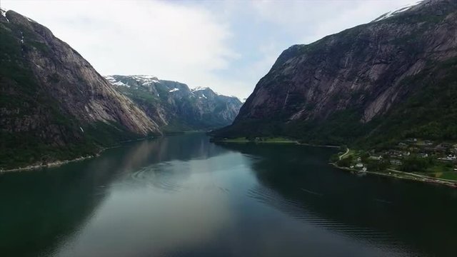 Slow flight above waters of Hardanger fjord in Norway, popular tourist destination. Aerial 4k Ultra HD.