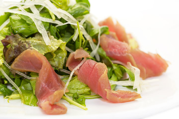 salad of arugula and tuna vegetables on a white background in the restaurant