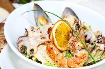 salad with vegetables and seafood on the table in a restaurant
