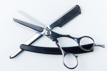 hair cutting scissors and razor blade for hairdressers.