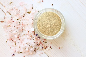 Cosmetic clay powder in jar and herbal aromatic salt. Healthy skin care. 