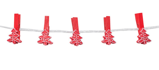 Christmas decorations, empty red spruce clothespegs (clothespin) hang on a rope, isolated on the white