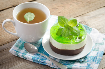 herbal tea with cake on wooden background.