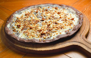 Handmade chocolate pizza with raisins and nuts