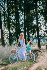 Caucasian child and his mother walking by rural countryside
