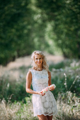 portrait of a beautiful sexy smiling girl with a wreath on his head in the spring park