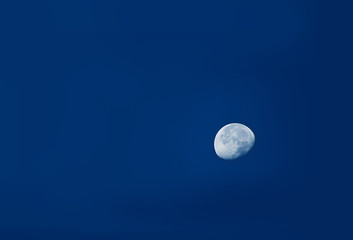 Naklejka na ściany i meble The moon in a blue sky at night