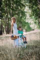 beautiful woman rolls the baby on the big bike