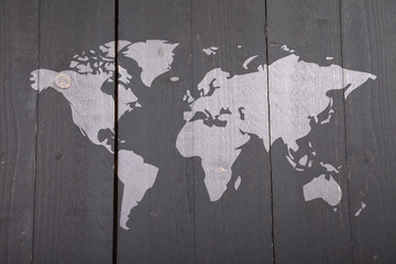 World map on dark black wooden background