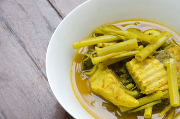 Thailand yellow curry of fish and morning glory.