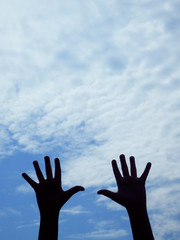 hands silhouettes and blue sky