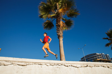 Man running over the blue sky