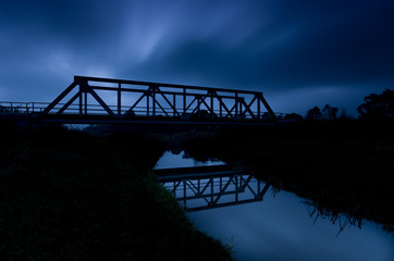 Railway steel truss bridge in Poland, over small river 