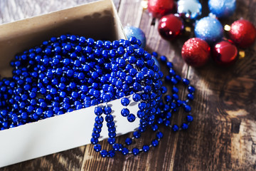 Box with Christmas tree decorations, garland