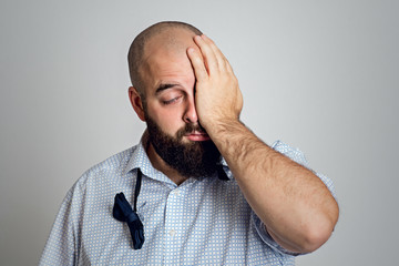 young bearded man is tired after party