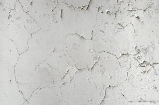 old crack and grunge stucco white wall on vintage house