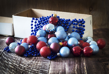 Box with Christmas tree decorations, garland
