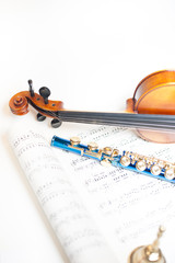 Wood violin detail with blue flute and score